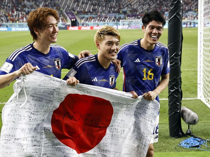 DOHA, QATAR - DECEMBER 01: Ritsu Doan, Hidemasa Morita and Ao Tanaka of Japan celebrate their 2-1 victory and qualification for the knockout stage after during the FIFA World Cup Qatar 2022 Group E match between Japan and Spain at Khalifa International Stadium on December 01, 2022 in Doha, Qatar. (Photo by Clive Mason/Getty Images)