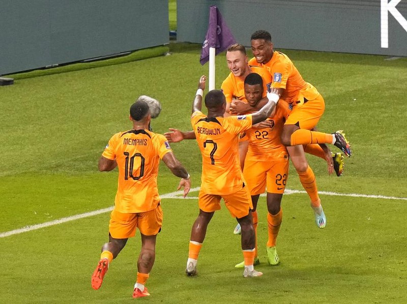 Denzel Dumfries of the Netherlands, 2nd right, celebrates after scoring his side's third goal during the World Cup round of 16 soccer match between the Netherlands and the United States, at the Khalifa International Stadium in Doha, Qatar, Saturday, Dec. 3, 2022. (AP Photo/Luca Bruno)