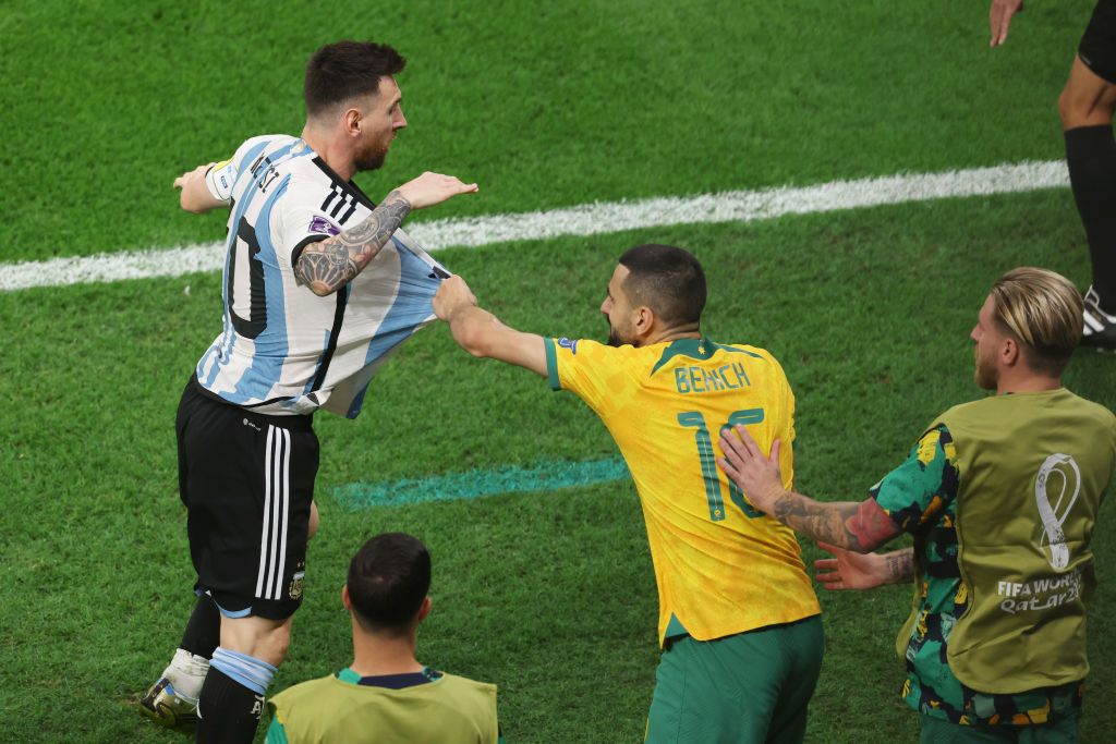DOHA, QATAR - DECEMBER 03: Lionel Messi of Argentina tussles with Aziz Behich of Australia during the FIFA World Cup Qatar 2022 Round of 16 match between Argentina and Australia at Ahmad Bin Ali Stadium on December 03, 2022 in Doha, Qatar. (Photo by Alexander Hassenstein/Getty Images)