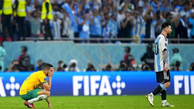 Australia's Aziz Behich, left, and Argentina's Lionel Messi react at the end of the World Cup round of 16 soccer match between Argentina and Australia at the Ahmad Bin Ali Stadium in Doha, Qatar, Saturday, Dec. 3, 2022. (AP Photo/Petr David Josek)