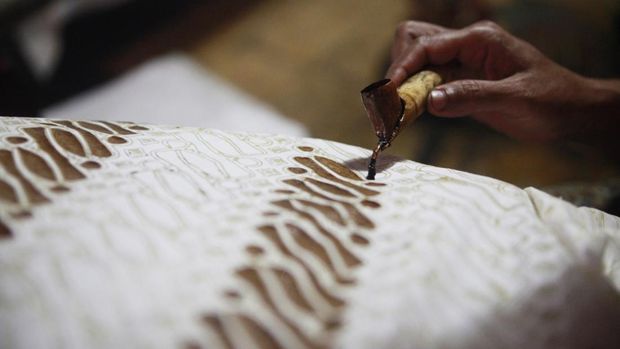 Batik or mbatik is a wax-resist dyeing technique to paint on a cloth. This technique originated from Java, Indonesia. To made batik paintings they usually used canting, a spouted tool for drawing dots and lines. This picture was taken in Kauman village, a village that famous for its Batik production in Solo, Central Java, Indonesia.