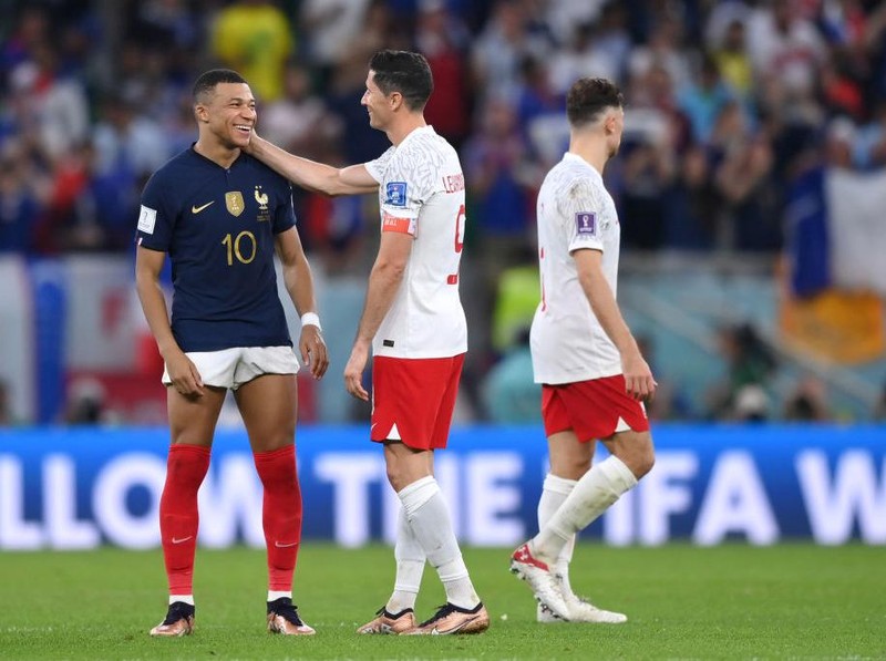 DOHA, QATAR - DECEMBER 04: Robert Lewandowski of Poland embraces Kylian Mbappe of France after the FIFA World Cup Qatar 2022 Round of 16 match between France and Poland at Al Thumama Stadium on December 04, 2022 in Doha, Qatar. (Photo by Buda Mendes/Getty Images)