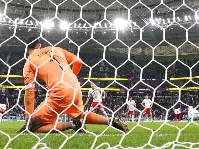 Poland's Robert Lewandowski scores on a penalty during the World Cup round of 16 soccer match between France and Poland, at the Al Thumama Stadium in Doha, Qatar, Sunday, Dec. 4, 2022. France won 3-1. (AP Photo/Natacha Pisarenko)