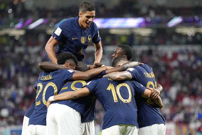 French players celebrate scoring their side's third goal during the World Cup round of 16 soccer match between France and Poland, at the Al Thumama Stadium in Doha, Qatar, Sunday, Dec. 4, 2022. (AP Photo/Martin Meissner)