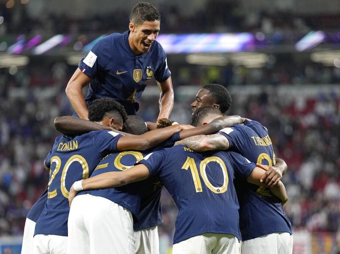 French players celebrate scoring their side's third goal during the World Cup round of 16 soccer match between France and Poland, at the Al Thumama Stadium in Doha, Qatar, Sunday, Dec. 4, 2022. (AP Photo/Martin Meissner)
