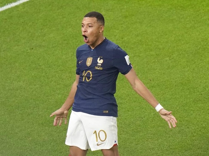 France's Kylian Mbappe, left, celebrates after scoring the third goal for his side during the World Cup round of 16 soccer match between France and Poland, at the Al Thumama Stadium in Doha, Qatar, Sunday, Dec. 4, 2022. (AP Photo/Luca Bruno)