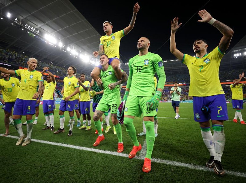 DOHA, QATAR - DECEMBER 05: Neymar of Brazil celebrates with Raphinha, Lucas Paqueta and Vinicius Junior after scoring the team's second goal via a penalty during the FIFA World Cup Qatar 2022 Round of 16 match between Brazil and South Korea at Stadium 974 on December 05, 2022 in Doha, Qatar. (Photo by Francois Nel/Getty Images)
