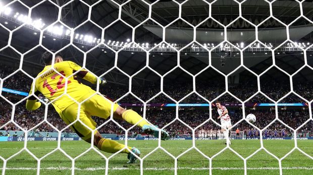 AL WAKRAH, QATAR - DECEMBER 05: (EDITORS NOTE: In this photo taken from a remote camera from behind the goal) Mario Pasalic of Croatia scores the sides winning penalty in the penalty shoot out past Shuichi Gonda of Japan during the FIFA World Cup Qatar 2022 Round of 16 match between Japan and Croatia at Al Janoub Stadium on December 05, 2022 in Al Wakrah, Qatar. (Photo by Maja Hitij - FIFA/FIFA via Getty Images)