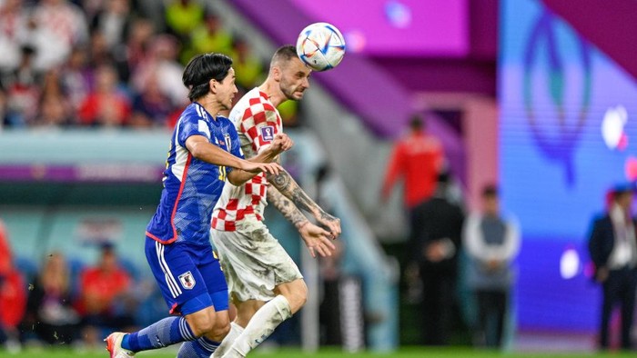 AL WAKRAH, QATAR - DECEMBER 5: Takumi Minamino of Japan battles for the ball with Marcelo Brozovic of Croatia during the Round of 16 - FIFA World Cup Qatar 2022 match between Japan and Croatia at the Al Janoub Stadium on December 5, 2022 in Al Wakrah, Qatar (Photo by Pablo Morano/BSR Agency/Getty Images)