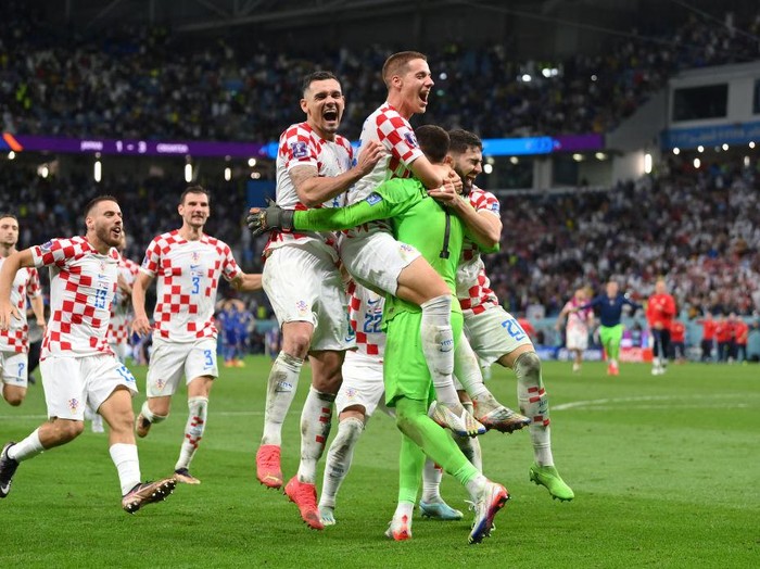 AL WAKRAH, QATAR - DECEMBER 05: Croatia players celebrate after winning the penalty shoot out during the FIFA World Cup Qatar 2022 Round of 16 match between Japan and Croatia at Al Janoub Stadium on December 05, 2022 in Al Wakrah, Qatar. (Photo by Dan Mullan/Getty Images)