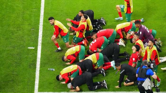 Morocco's team players celebrate as they won the World Cup round of 16 soccer match between Morocco and Spain, at the Education City Stadium in Al Rayyan, Qatar, Tuesday, Dec. 6, 2022. (AP Photo/Petr David Josek)