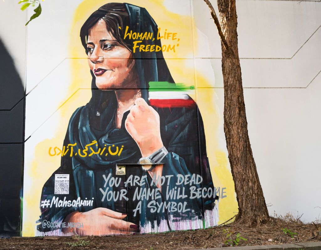 SYDNEY, AUSTRALIA - NOVEMBER 04:  A new mural of Mahsa Amini,  to show support for the people of Iran, is presented by artist Scott Marsh, on November 04, 2022 in Sydney, Australia. Protests have spread across Iran in response to the death of Amini, who was arrested for not covering her head properly in the view of religious police, and was killed while in custody. Several protesters have since been arrested and also have died in the hands of Iranian police. (Photo by Saverio Marfia/Getty Images)