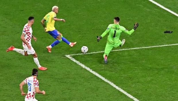 Brazil's forward #10 Neymar shoots but fails to score past Croatia's goalkeeper #01 Dominik Livakovic during the Qatar 2022 World Cup quarter-final football match between Croatia and Brazil at Education City Stadium in Al-Rayyan, west of Doha, on December 9, 2022. (Photo by INA FASSBENDER / AFP)