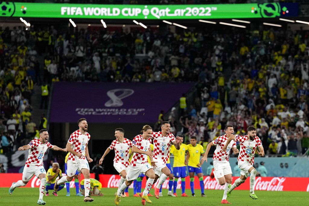 Croatia's players celebrate after the penalty shootout at the World Cup quarterfinal soccer match between Croatia and Brazil, at the Education City Stadium in Al Rayyan, Qatar, Friday, Dec. 9, 2022. (AP Photo/Martin Meissner)