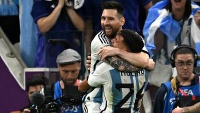Argentinas defender #26 Nahuel Molina celebrates with Argentinas forward #10 Lionel Messi after scoring his teams first goal during the Qatar 2022 World Cup quarter-final football match between Netherlands and Argentina at Lusail Stadium, north of Doha, on December 9, 2022. (Photo by MANAN VATSYAYANA / AFP)