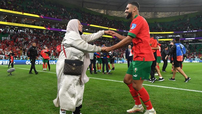 DOHA, QATAR - DECEMBER 10: Sofiane Boufal of Morocco celebrates with a family member after the teams 1-0 victory in the FIFA World Cup Qatar 2022 quarter final match between Morocco and Portugal at Al Thumama Stadium on December 10, 2022 in Doha, Qatar. (Photo by Mike Hewitt - FIFA/FIFA via Getty Images)