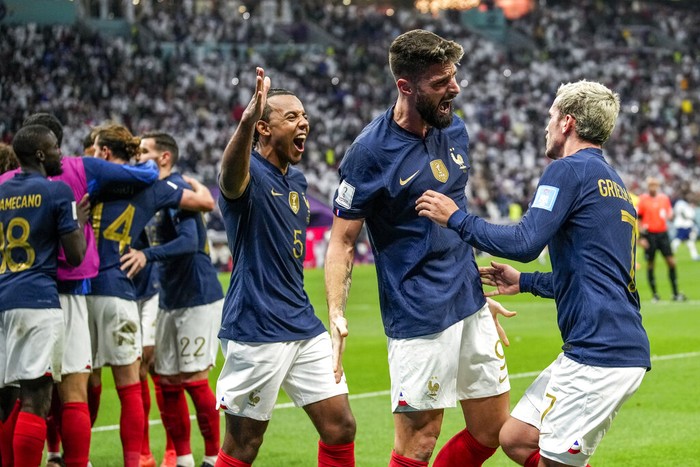 Frances Olivier Giroud celebrates with his teammates after scoring his sides second goal during the World Cup quarterfinal soccer match between England and France, at the Al Bayt Stadium in Al Khor, Qatar, Saturday, Dec. 10, 2022. (AP Photo/Christophe Ena)