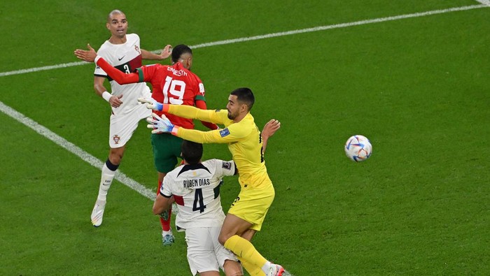 Morocco's forward #19 Youssef En-Nesyri scores his team's first goal past Portugal's defender #04 Ruben Dias and Portugal's goalkeeper #22 Diogo Costa as Portugal's defender #03 Pepe looks on during the Qatar 2022 World Cup quarter-final football match between Morocco and Portugal at the Al-Thumama Stadium in Doha on December 10, 2022. (Photo by NELSON ALMEIDA / AFP) (Photo by NELSON ALMEIDA/AFP via Getty Images)