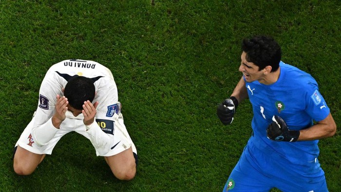 Portugals forward #07 Cristiano Ronaldo reacts beside Moroccos goalkeeper #01 Yassine Bounou during the Qatar 2022 World Cup quarter-final football match between Morocco and Portugal at the Al-Thumama Stadium in Doha on December 10, 2022. (Photo by MANAN VATSYAYANA / AFP) (Photo by MANAN VATSYAYANA/AFP via Getty Images)