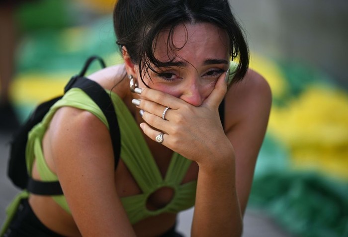 A fan of Brazil cries after watching the live broadcast of the Qatar 2022 World Cup Quarter-final round football match between Brazil and Croatia in Rio de Janeiro, Brazil, on December 9, 2022. (Photo by CARL DE SOUZA / AFP) (Photo by CARL DE SOUZA/AFP via Getty Images)