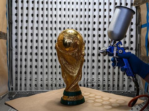 MILAN, ITALY - NOVEMBER 21: A personnel works on a World Cup trophy at the GDE Bertoni headquarters in Milan, Italy on November 21, 2022. GDE Bertoni headquarters is a small building situated in the industrial area of Paderno Dugnano, a town on the outskirts of Milan, northern Italy. It has two floors of offices and workshops and a dozen employees. The company is one of the tens of thousands of small and medium enterprises that make up the backbone of the Italian economy and contribute to making it one of the most prosperous in the world. But it is here that one of the most iconic objects on the planet has been produced for the past 50 years: the World Cup trophy. (Photo by Piero Cruciatti/Anadolu Agency via Getty Images)