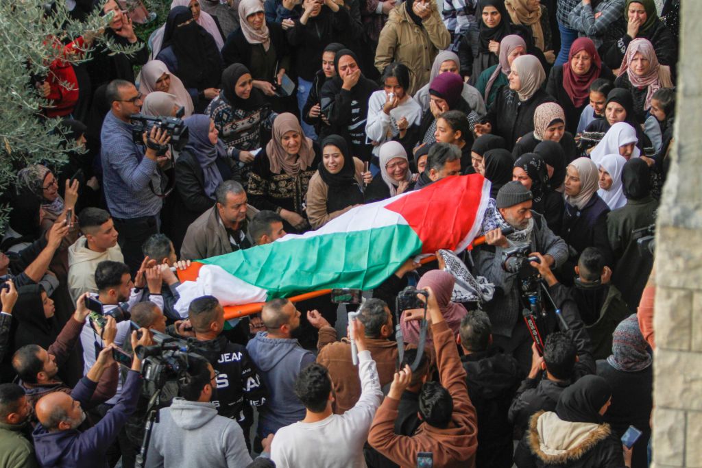 JENIN, WEST BANK, PALESTINE - 2022/12/12: (EDITOR'S NOTE : Image depicts death)Mourners carry the body of 15-year-old Palestinian Jana Zakarneh in the city of Jenin in the occupied West Bank. Jana was shot dead by the Israeli army while she was on the roof of her house, during an army raid on the city. (Photo by Nasser Ishtayeh/SOPA Images/LightRocket via Getty Images)