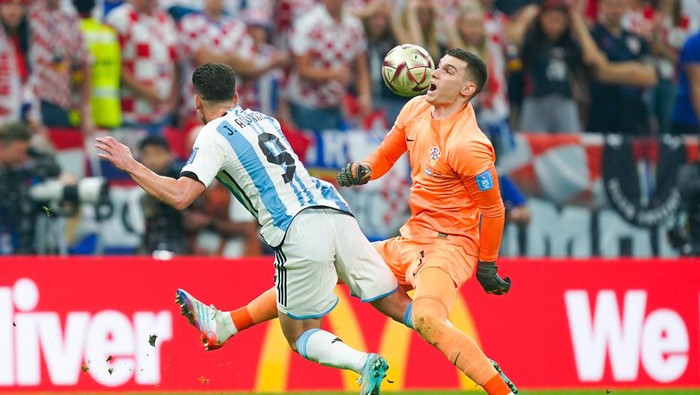 LUSAIL CITY, QATAR - DECEMBER 13: Dominik Livakovic (R) goalkeeper of Croatia fights for the ball with Julian Alvarez (L) of Argentina during the FIFA World Cup Qatar 2022 semi final match between Argentina and Croatia at Lusail Stadium on December 13, 2022 in Lusail City, Qatar. (Photo by Khalil Bashar/Jam Media/Getty Images)