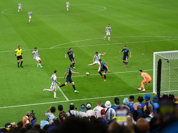 LUSAIL CITY, QATAR - DECEMBER 13: Julian Alvarez of Argentina scores the team's third goal past Dominik Livakovic of Croatia during the FIFA World Cup Qatar 2022 semi final match between Argentina and Croatia at Lusail Stadium on December 13, 2022 in Lusail City, Qatar. (Photo by David Ramos - FIFA/FIFA via Getty Images)