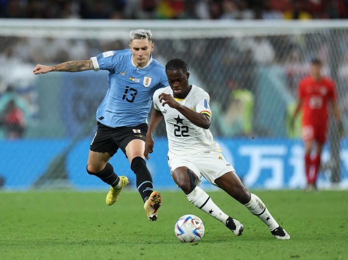 AL WAKRAH, QATAR - DECEMBER 02: Kamaldeen Sulemana of Ghana battles for possession with Guillermo Varela of Uruguay   during the FIFA World Cup Qatar 2022 Group H match between Ghana and Uruguay at Al Janoub Stadium on December 02, 2022 in Al Wakrah, Qatar. (Photo by Maja Hitij - FIFA/FIFA via Getty Images)