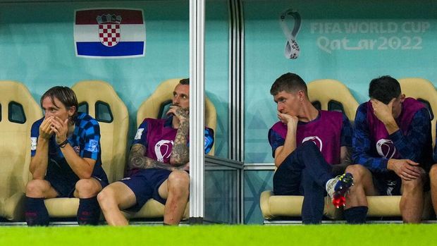 Croatia's Luka Modric, left, sits on the bench as he watches the World Cup semifinal soccer match between Argentina and Croatia at the Lusail Stadium in Lusail, Qatar, Tuesday, Dec. 13, 2022. (AP Photo/Petr David Josek)