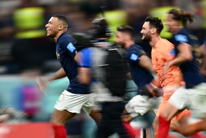 Frances forward #10 Kylian Mbappe (L) celebrates with teammates after they won the Qatar 2022 World Cup quarter-final football match between England and France at the Al-Bayt Stadium in Al Khor, north of Doha, on December 10, 2022. (Photo by GABRIEL BOUYS / AFP) (Photo by GABRIEL BOUYS/AFP via Getty Images)