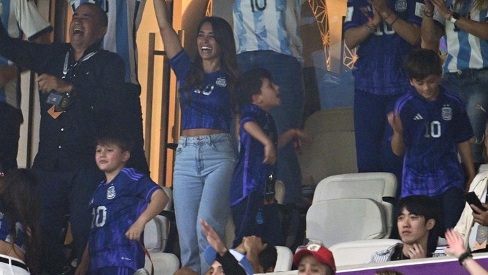 LUSAIL CITY, QATAR - DECEMBER 13: Antonela Roccuzzo, wife of Lionel Messi of Argentina, Celia Maria Cuccittini, mother of Lionel Messi of Argentina celebrate with family members and supporters after the second goal by Julian Alvarez during the FIFA World Cup Qatar 2022 semi final match between Argentina and Croatia at Lusail Stadium on December 13, 2022 in Lusail City, Qatar. (Photo by Matthias Hangst/Getty Images)