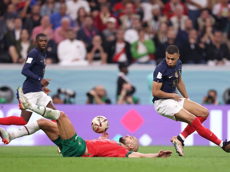 AL KHOR, QATAR - DECEMBER 14: Sofyan Amrabat of Morocco is fouled by Kylian Mbappe of France during the FIFA World Cup Qatar 2022 semi final match between France and Morocco at Al Bayt Stadium on December 14, 2022 in Al Khor, Qatar. (Photo by Maddie Meyer - FIFA/FIFA via Getty Images)