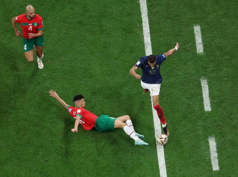 AL KHOR, QATAR - DECEMBER 14: Kylian Mbappe of France goes past Achraf Dari of Morocco during the FIFA World Cup Qatar 2022 semi final match between France and Morocco at Al Bayt Stadium on December 14, 2022 in Al Khor, Qatar. (Photo by Maja Hitij - FIFA/FIFA via Getty Images)
