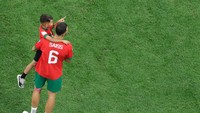 Romain Saiss tampak menggendong putranya.