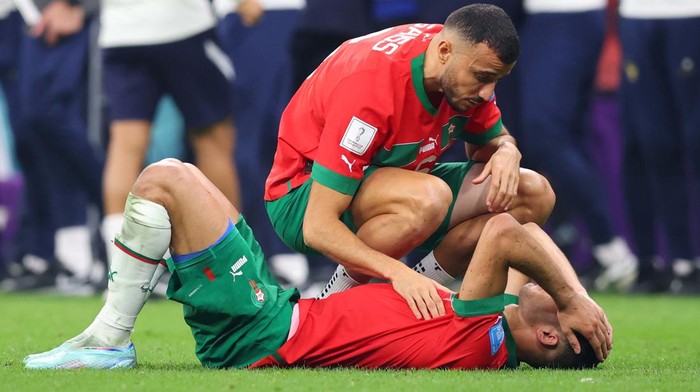 AL KHOR, QATAR - DECEMBER 14: Romain Saïss of Morocco (L) and Achraf Hakimi of Morocco after the FIFA World Cup Qatar 2022 semi final match between France and Morocco at Al Bayt Stadium on December 14, 2022 in Al Khor, Qatar. (Photo by Sebastian Frej/MB Media/Getty Images)