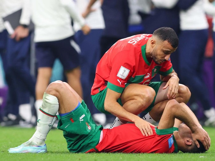 AL KHOR, QATAR - DECEMBER 14: Romain Saïss of Morocco (L) and Achraf Hakimi of Morocco after the FIFA World Cup Qatar 2022 semi final match between France and Morocco at Al Bayt Stadium on December 14, 2022 in Al Khor, Qatar. (Photo by Sebastian Frej/MB Media/Getty Images)
