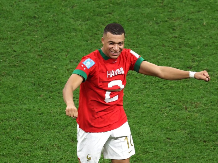 AL KHOR, QATAR - DECEMBER 14: Kylian Mbappe of France celebrates the 2-0 win after exchanging shirts with Achraf Hakimi of Morocco during the FIFA World Cup Qatar 2022 semi final match between France and Morocco at Al Bayt Stadium on December 14, 2022 in Al Khor, Qatar. (Photo by Clive Brunskill/Getty Images)