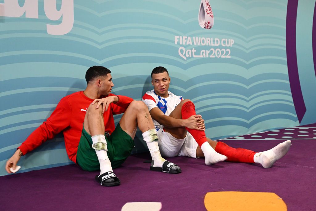 AL KHOR, QATAR - DECEMBER 14: Achraf Hakimi of Morocco talks with Kylian Mbappe of France after the 2022 FIFA World Cup Qatar semi-final match between France and Morocco at Al Bayt Stadium on December 14, 2022 in Al Khor, Qatar.  (Photo by Michael Regan - FIFA/FIFA via Getty Images)