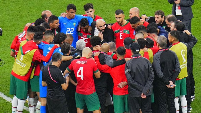 Moroccan players stand in a circle after the World Cup semifinal soccer match between France and Morocco at the Al Bayt Stadium in Al Khor, Qatar, Wednesday, Dec. 14, 2022. (AP Photo/Hassan Ammar)