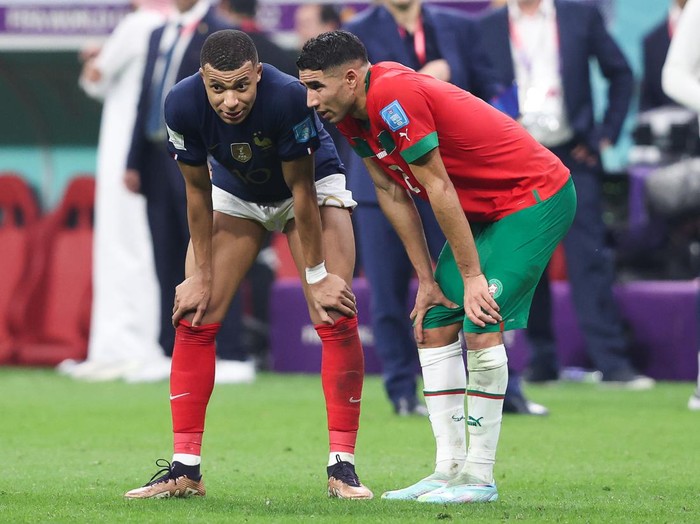 AL KHOR, QATAR - DECEMBER 14: Kylian Mbappe of France speaks with Paris Saint-Germain teammate Achraf Hakimi of Morocco after the FIFA World Cup Qatar 2022 semi final match between France and Morocco at Al Bayt Stadium on December 14, 2022 in Al Khor, Qatar. (Photo by Alex Livesey - Danehouse/Getty Images)