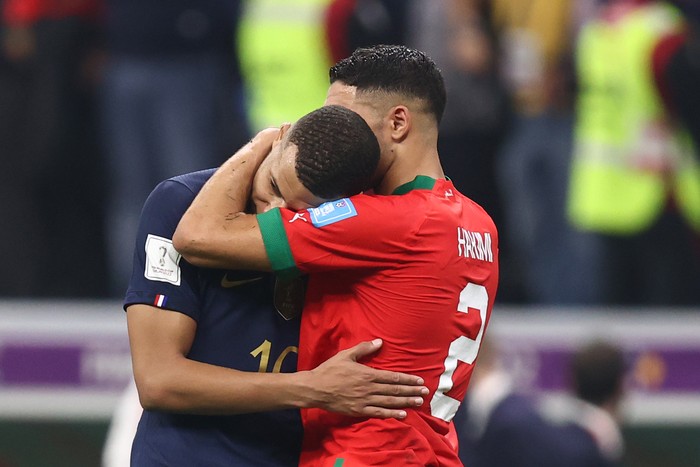 AL KHOR, QATAR - DECEMBER 14: Kylian Mbappe of France embraces fellow PSG team mate Achraf Hakimi of Morocco  during the FIFA World Cup Qatar 2022 semi final match between France and Morocco at Al Bayt Stadium on December 14, 2022 in Al Khor, Qatar. (Photo by James Williamson - AMA/Getty Images)