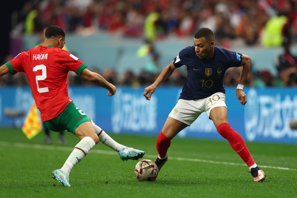 AL KHOR, QATAR - DECEMBER 14: Kylian Mbappé of France and Achraf Hakimi of Morocco in action during the FIFA World Cup Qatar 2022 semi final match between France and Morocco at Al Bayt Stadium on December 14, 2022 in Al Khor, Qatar. (Photo by Amin Mohammad Jamali/Getty Images)