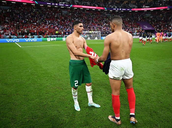 AL KHOR, QATAR - DECEMBER 14: Achraf Hakimi of Morocco swaps shirts with Kylian Mbappe of France after the FIFA World Cup Qatar 2022 semi final match between France and Morocco at Al Bayt Stadium on December 14, 2022 in Al Khor, Qatar. (Photo by Michael Regan - FIFA/FIFA via Getty Images)
