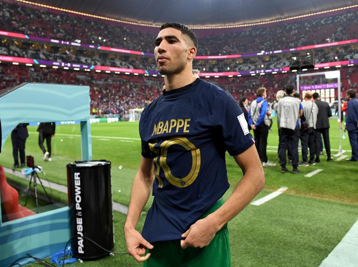AL KHOR, QATAR - DECEMBER 14: Achraf Hakimi of Morocco walks off the pitch after exchanging shirts with Kylian Mbappe of France during the FIFA World Cup Qatar 2022 semi final match between France and Morocco at Al Bayt Stadium on December 14, 2022 in Al Khor, Qatar. (Photo by David Ramos - FIFA/FIFA via Getty Images)