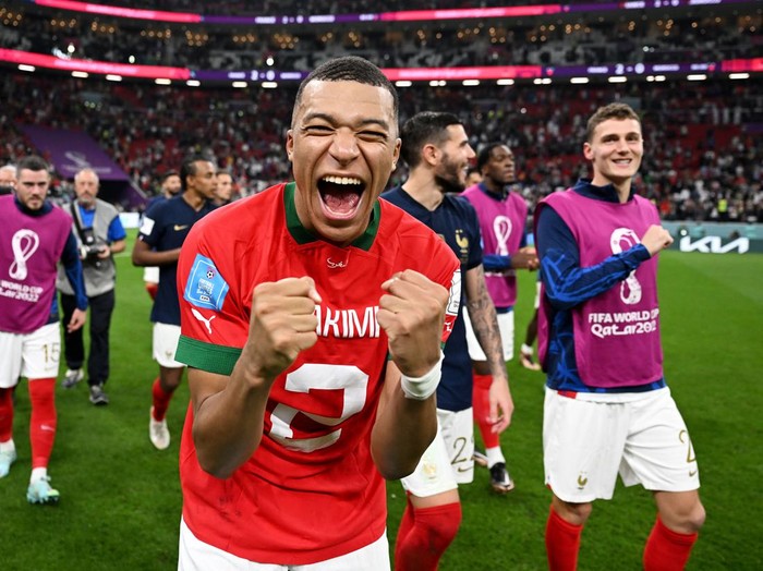 AL KHOR, QATAR - DECEMBER 14: Kylian Mbappe of France celebrates the 2-0 win after exchanging shirts with Achraf Hakimi of Morocco (not pictured) during the FIFA World Cup Qatar 2022 semi final match between France and Morocco at Al Bayt Stadium on December 14, 2022 in Al Khor, Qatar. (Photo by Michael Regan - FIFA/FIFA via Getty Images)