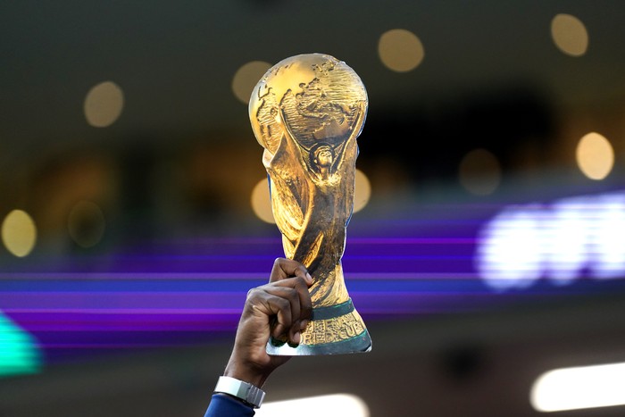 A fan holds up a replica World Cup trophy before the FIFA World Cup Semi-Final match at the Al Bayt Stadium in Al Khor, Qatar. Picture date: Wednesday December 14, 2022. (Photo by Adam Davy/PA Images via Getty Images)