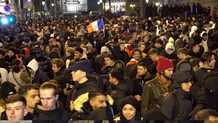 PARIS, FRANCE - DECEMBER 15: Fans of France celebrate victory after France defeated Morocco in FIFA World Cup Qatar 2022 semi-final match at Champs Elysees in Paris, France on December 15, 2022. (Photo by Dursun Aydemir/Anadolu Agency via Getty Images)
