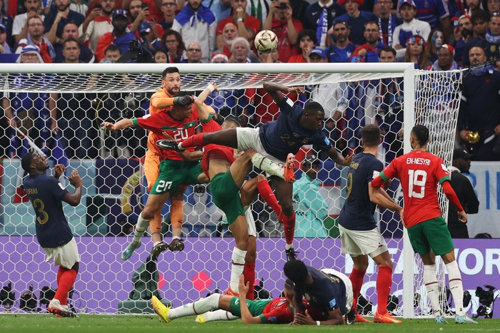 TOPSHOT - Frances goalkeeper #01 Hugo Lloris and players jump for the ball during the Qatar 2022 World Cup semi-final football match between France and Morocco at the Al-Bayt Stadium in Al Khor, north of Doha on December 14, 2022. (Photo by ADRIAN DENNIS / AFP) (Photo by ADRIAN DENNIS/AFP via Getty Images)