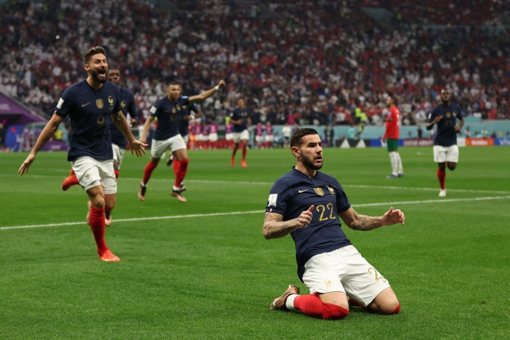 France's defender #22 Theo Hernandez celebrates, with France's forward #09 Olivier Giroud running behind, after scoring his team's first goal during the Qatar 2022 World Cup semi-final football match between France and Morocco at the Al-Bayt Stadium in Al Khor, north of Doha on December 14, 2022. (Photo by Adrian DENNIS / AFP) (Photo by ADRIAN DENNIS/AFP via Getty Images)